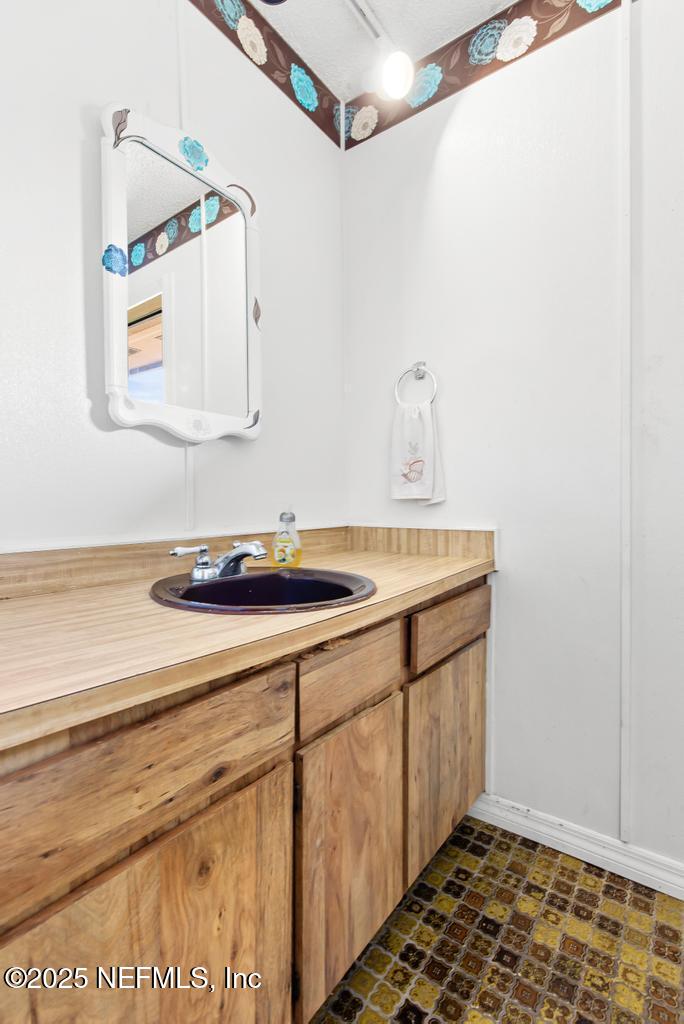 5342 Hickson Road Jacksonville, FL 32207 - Photo 15 of 19 a bathroom with a sink and a mirror