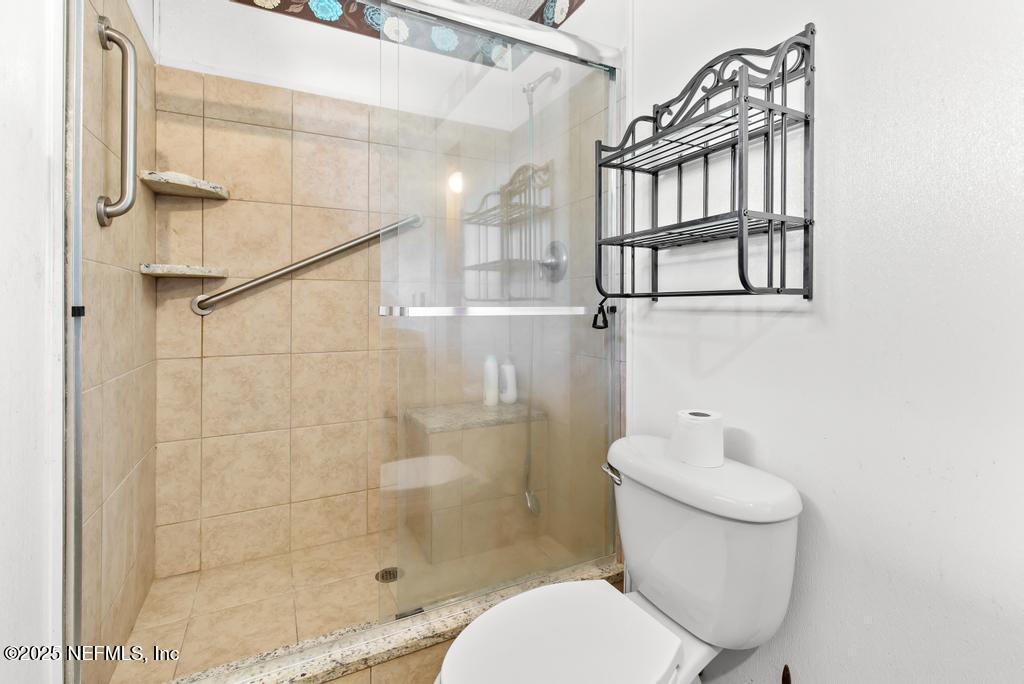 5342 Hickson Road Jacksonville, FL 32207 - Photo 16 of 19 a bathroom with a toilet and a shower