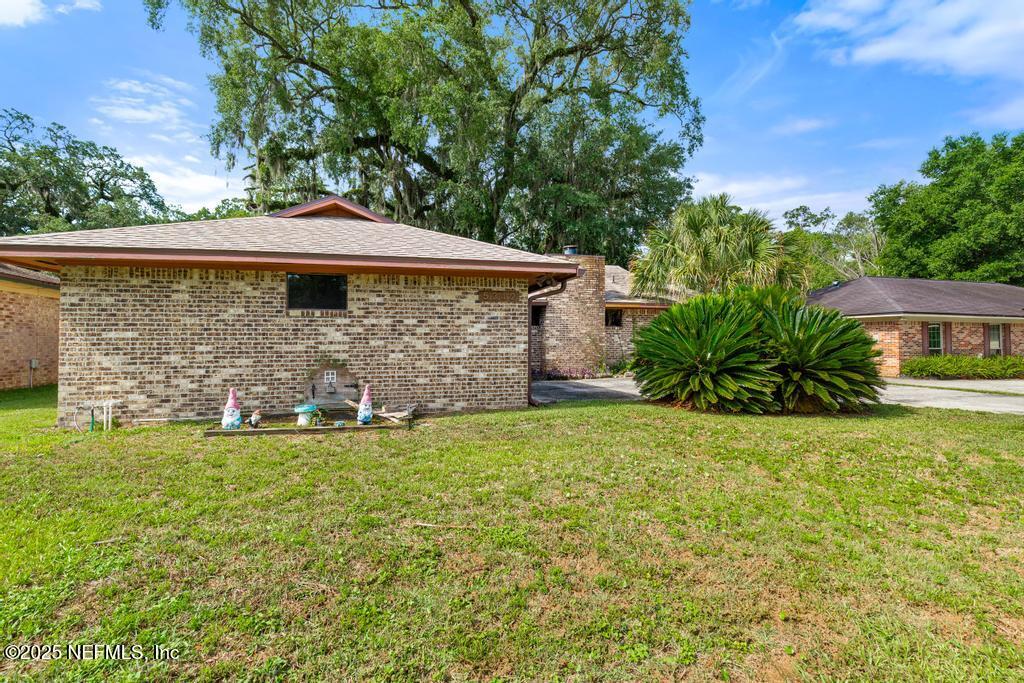 5342 Hickson Road Jacksonville, FL 32207 - Photo 2 of 19 a view of a backyard with table and chairs and potted plants