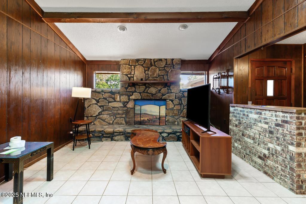 5342 Hickson Road Jacksonville, FL 32207 - Photo 5 of 19 a room with fireplace furniture and a flat screen tv