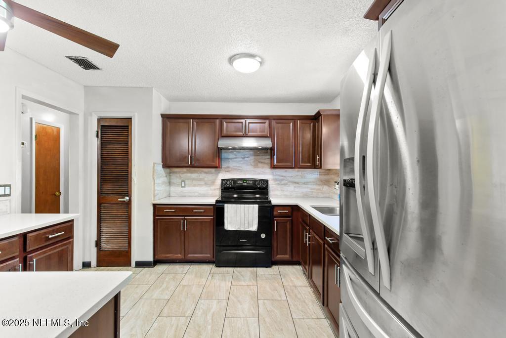 5342 Hickson Road Jacksonville, FL 32207 - Photo 7 of 19 a kitchen with stainless steel appliances granite countertop a refrigerator and a stove
