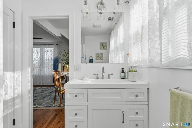 a bathroom with a double vanity sink mirror and