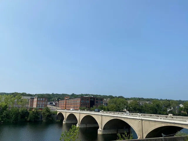 an aerial view of a residential houses with outdoor space and swimming pool