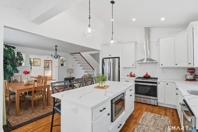 a kitchen that has a lot of cabinets and wooden floor