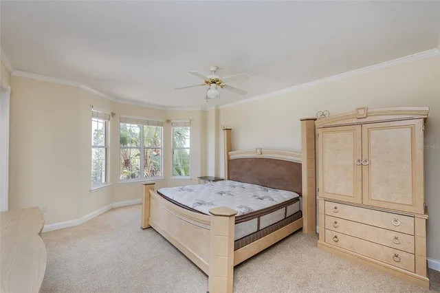 a spacious bedroom with a bed and a window