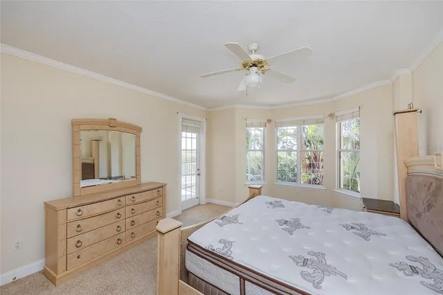a view of a bedroom with a dresser and a chandelier fan