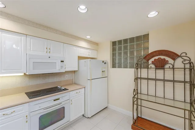 a kitchen with stainless steel appliances a refrigerator sink and cabinets
