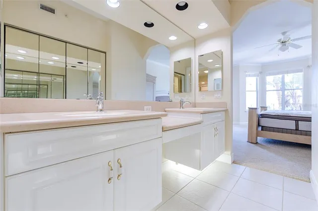 a bathroom with a sink a tub and a mirror