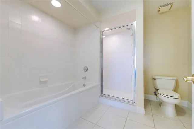 a spacious bathroom with a bathtub and a toilet