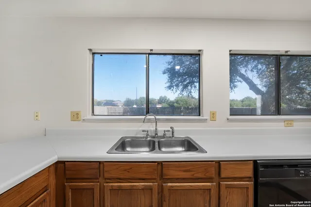 a kitchen with a sink and large window