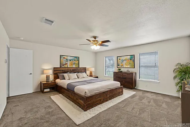 a bedroom with a large bed and a chandelier