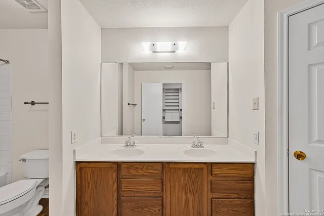 a bathroom with a sink double vanity and a mirror
