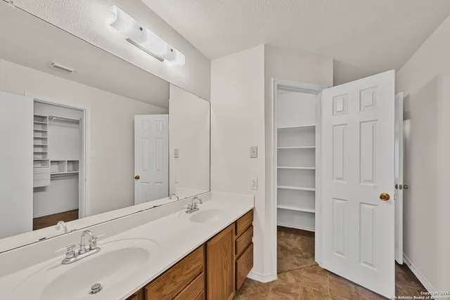 a bathroom with a double vanity sink mirror and double