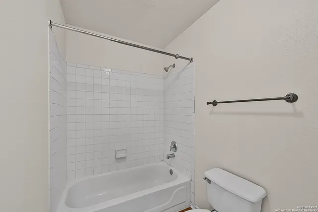 a bathroom with a shower and a toilet
