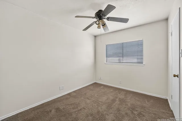 a view of room with a ceiling fan