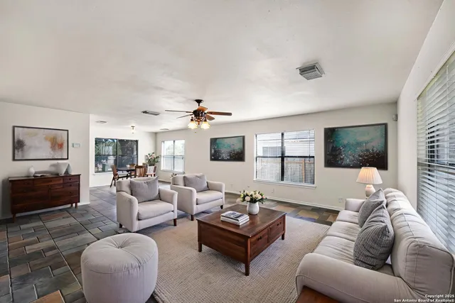 a living room with furniture and a large window