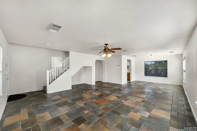 a view of a big room with closet and windows