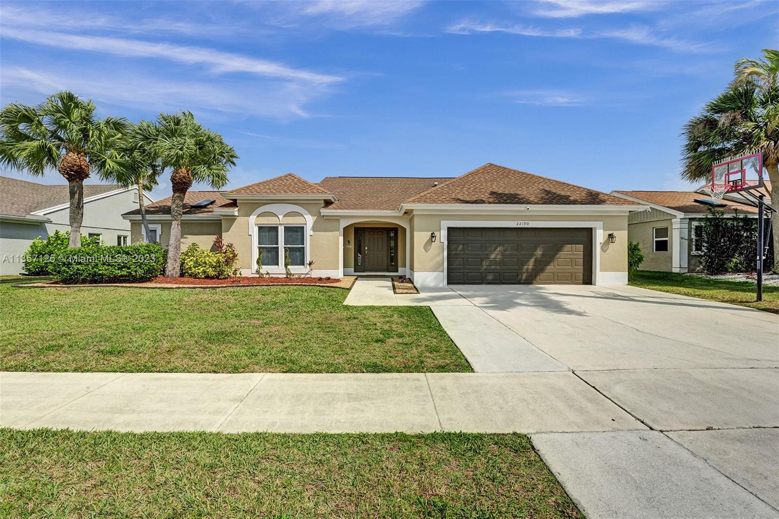 22190 Appleton Drive Boca Raton, FL 33428 - Photo 1 of 41 a front view of a house with a yard