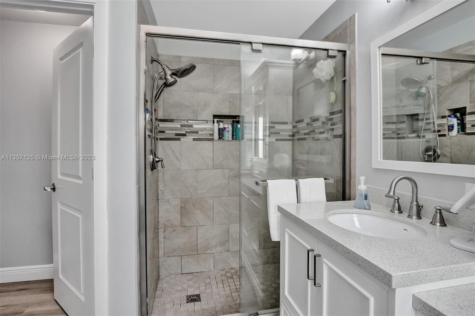 22190 Appleton Drive Boca Raton, FL 33428 - Photo 18 of 41 a bathroom with a granite countertop shower sink and mirror