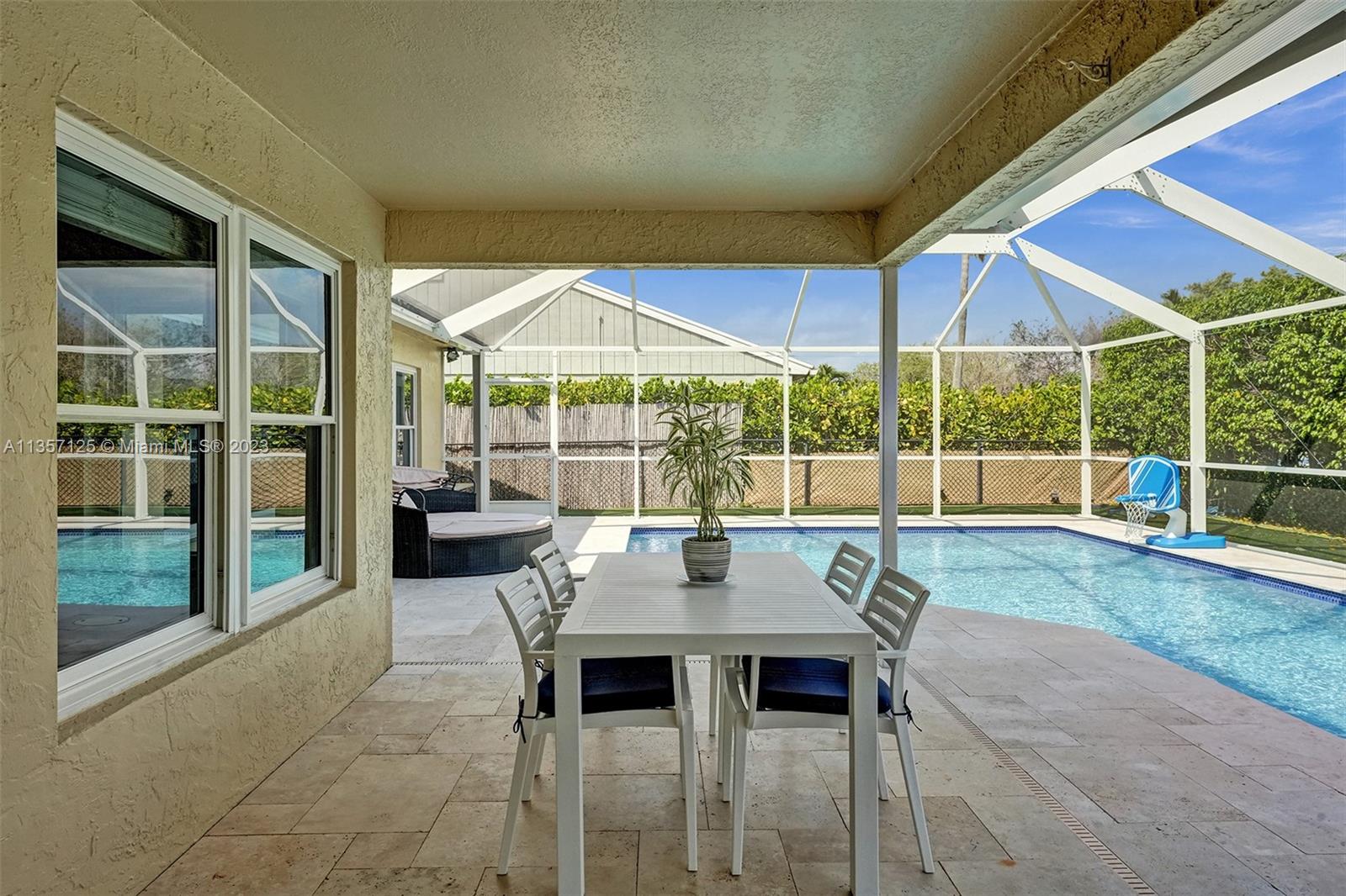22190 Appleton Drive Boca Raton, FL 33428 - Photo 25 of 41 a view of a patio with a table and chairs under an umbrella