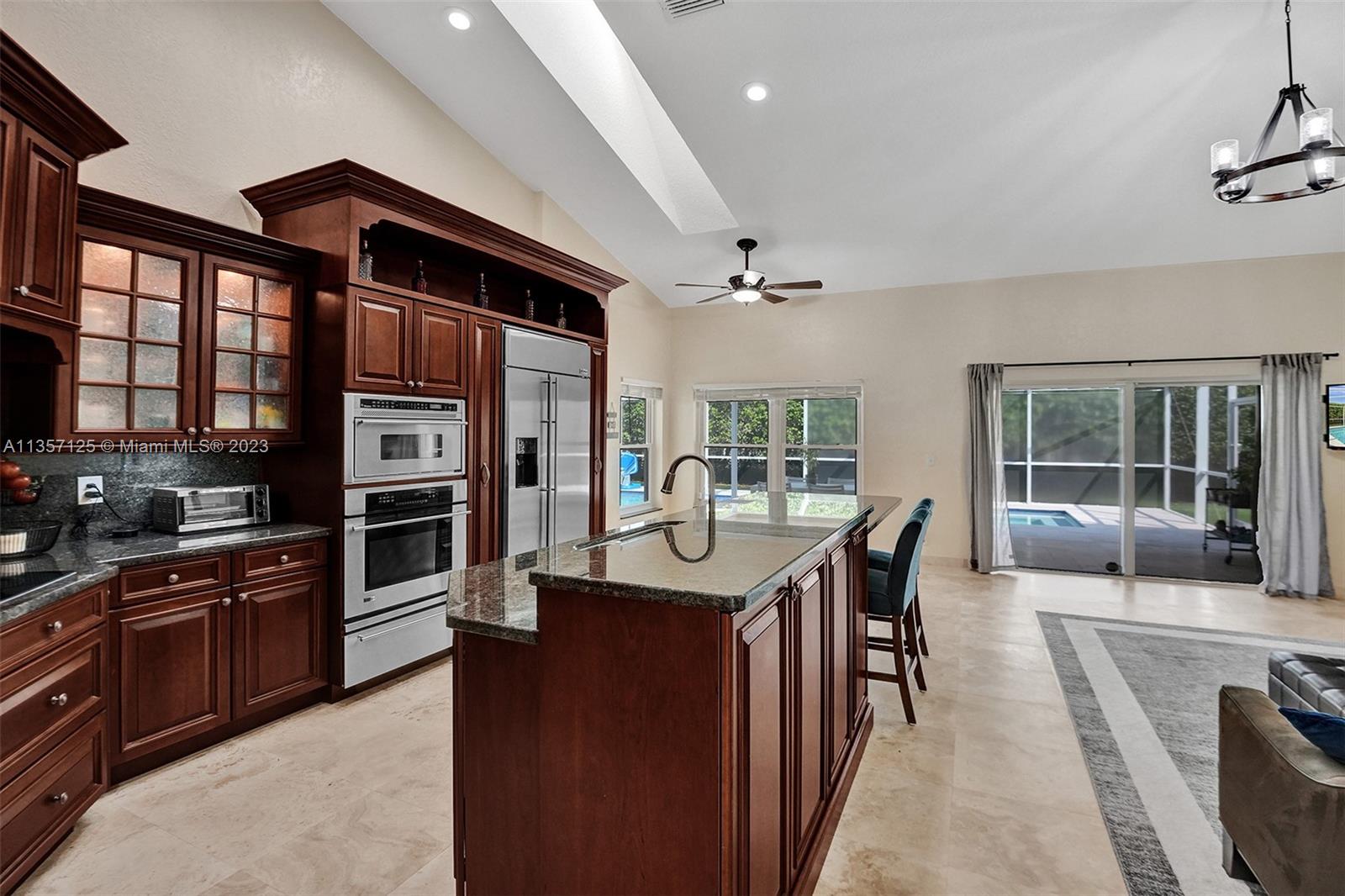 22190 Appleton Drive Boca Raton, FL 33428 - Photo 3 of 41 a kitchen with stainless steel appliances kitchen island granite countertop a stove a sink and a refrigerator