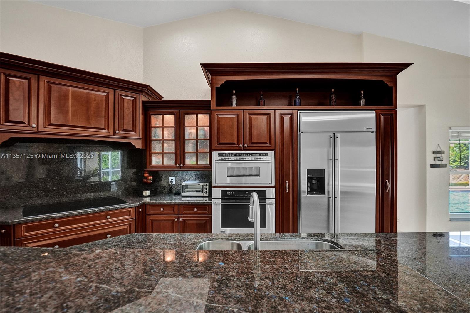 22190 Appleton Drive Boca Raton, FL 33428 - Photo 4 of 41 a kitchen with granite countertop a stove and a microwave oven