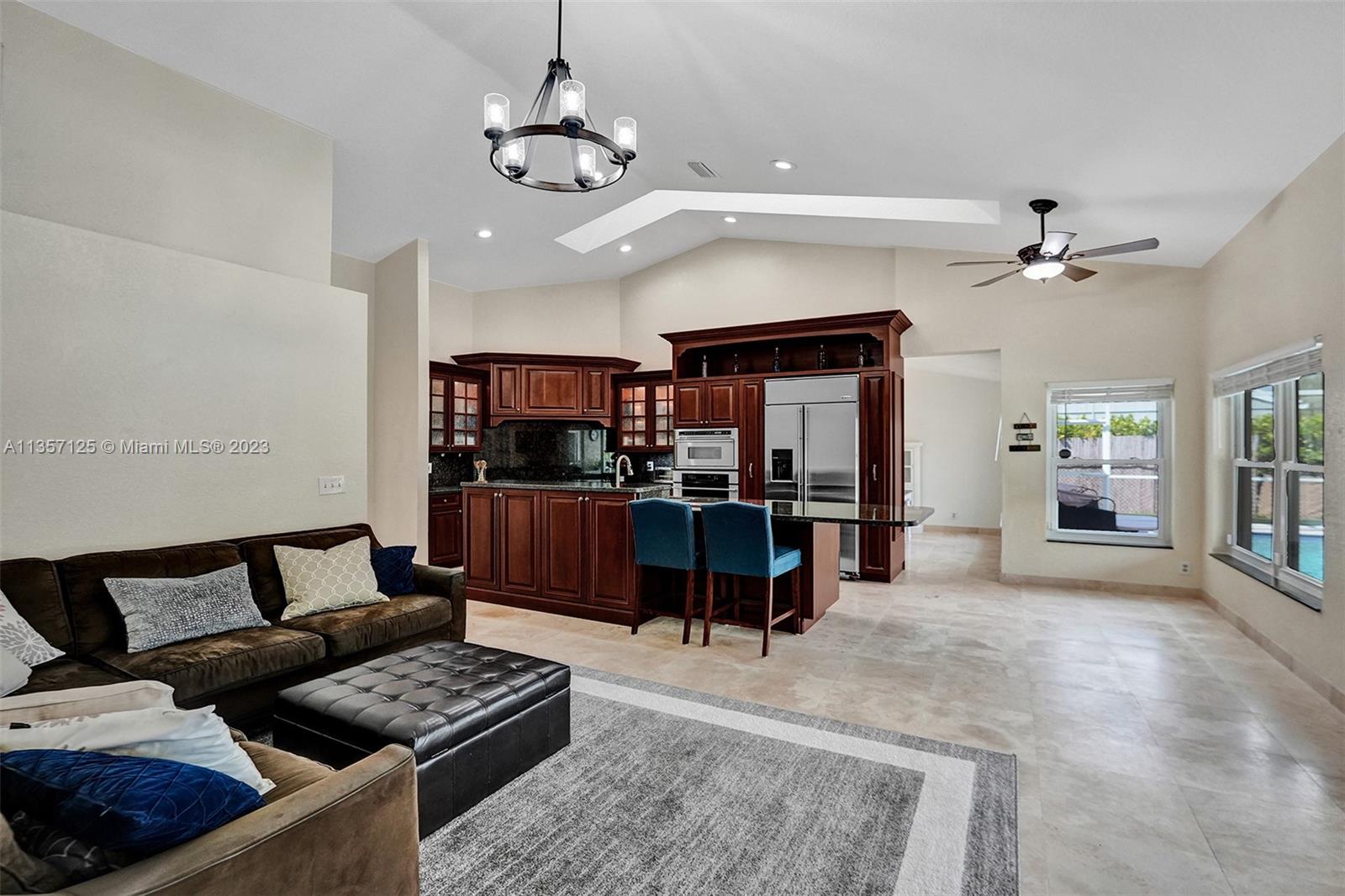 22190 Appleton Drive Boca Raton, FL 33428 - Photo 9 of 41 a living room with furniture and a chandelier