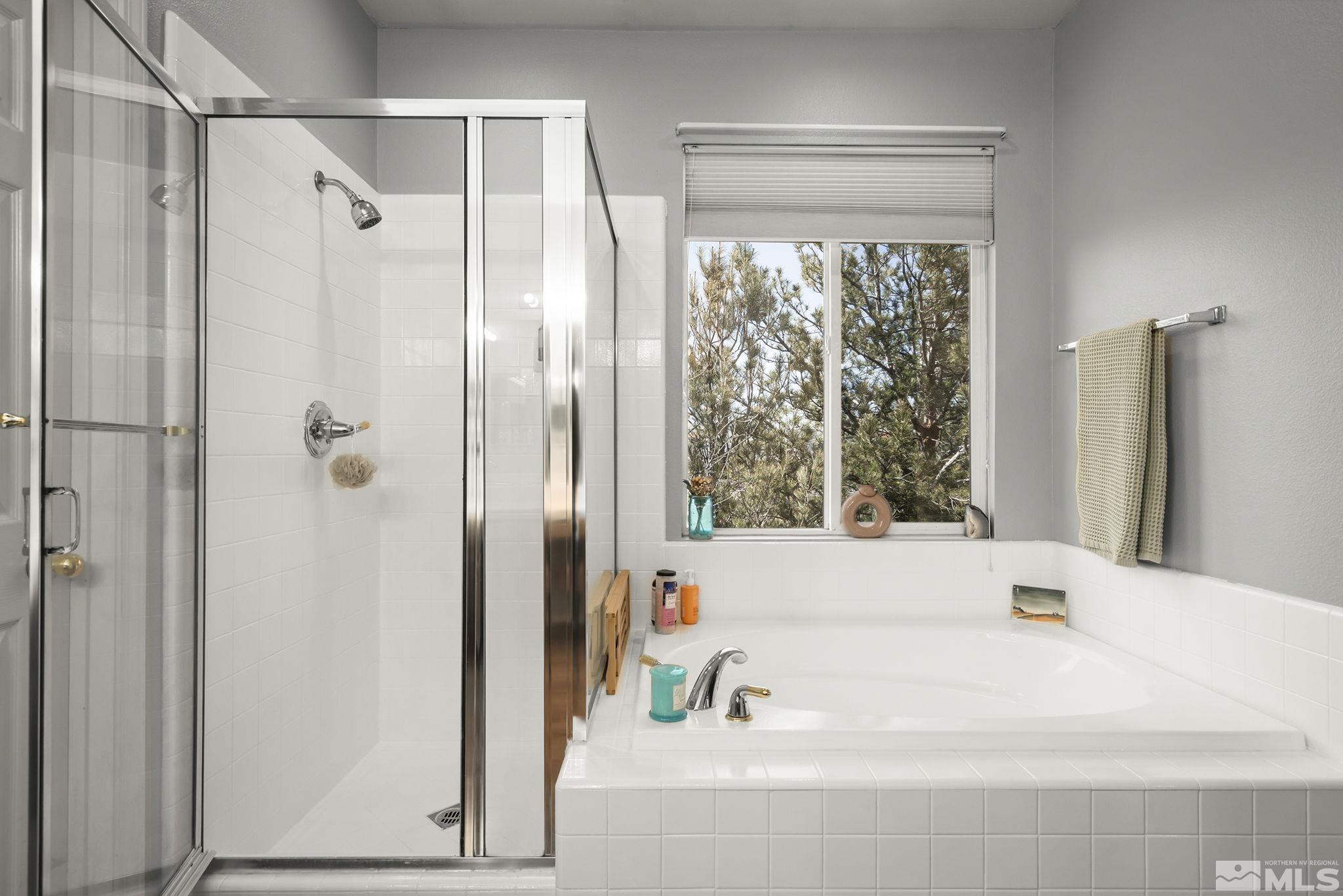 1465 Cayuse Way Reno, NV 89521 - Photo 12 of 26 a bathroom with a bathtub and a shower