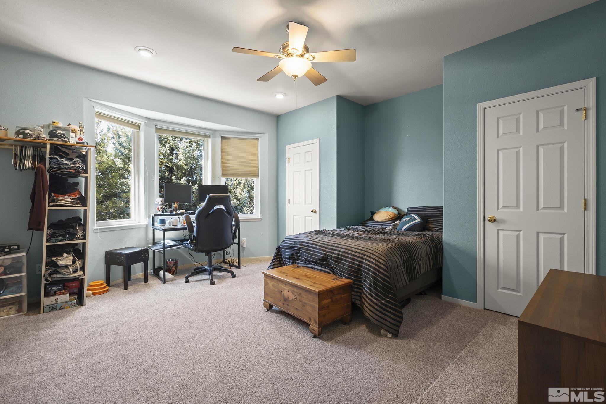 1465 Cayuse Way Reno, NV 89521 - Photo 13 of 26 a bedroom with bed and a chandelier