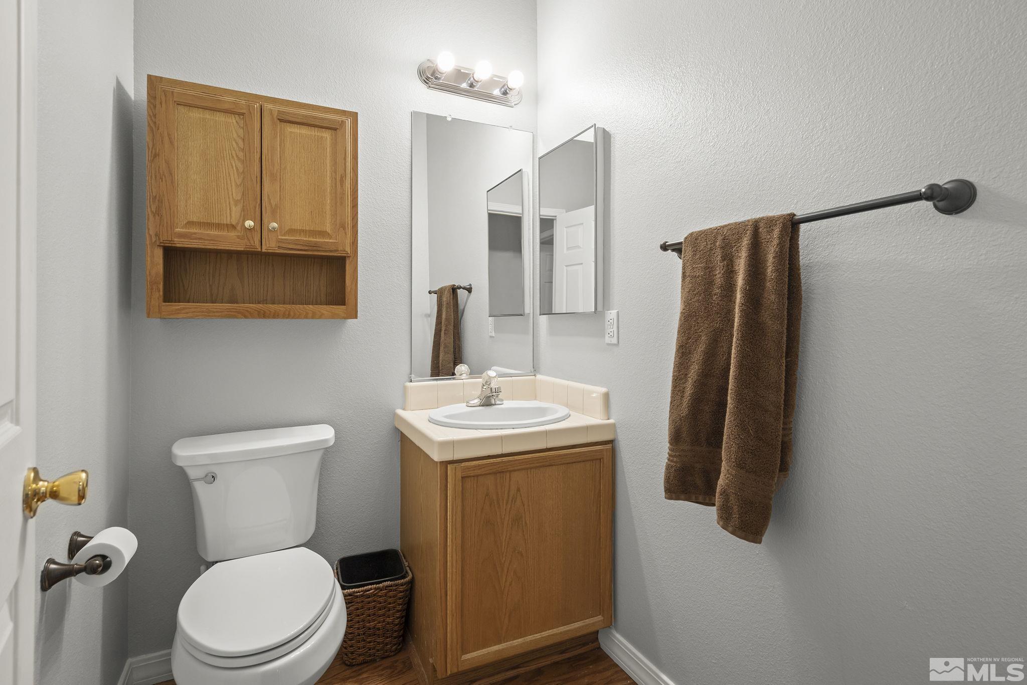 1465 Cayuse Way Reno, NV 89521 - Photo 17 of 26 a bathroom with a toilet sink and mirror