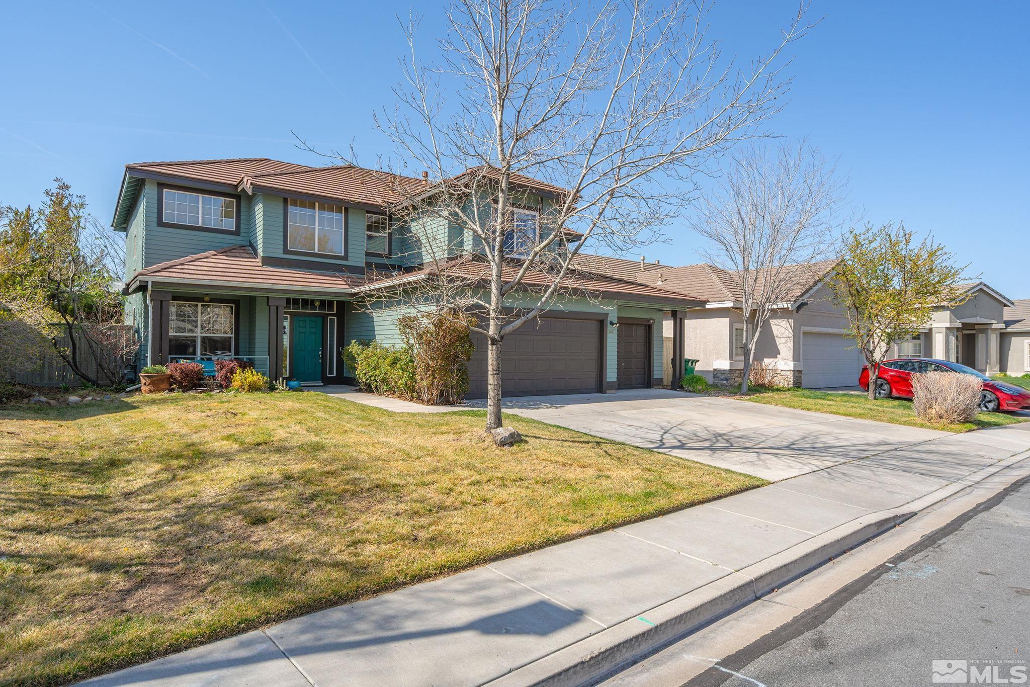 1465 Cayuse Way Reno, NV 89521 - Photo 23 of 26 a view of a white house with a swimming pool