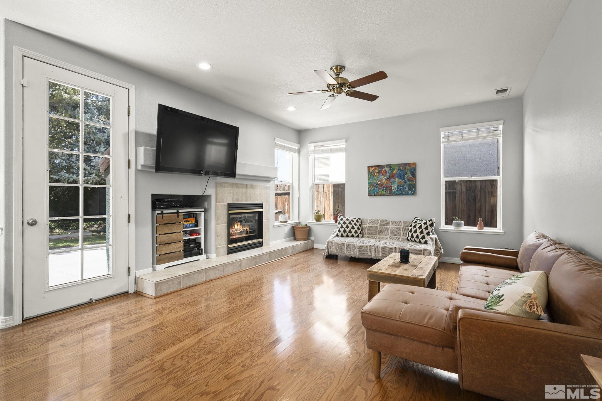 1465 Cayuse Way Reno, NV 89521 - Photo 5 of 26 a living room with furniture a flat screen tv and a fireplace