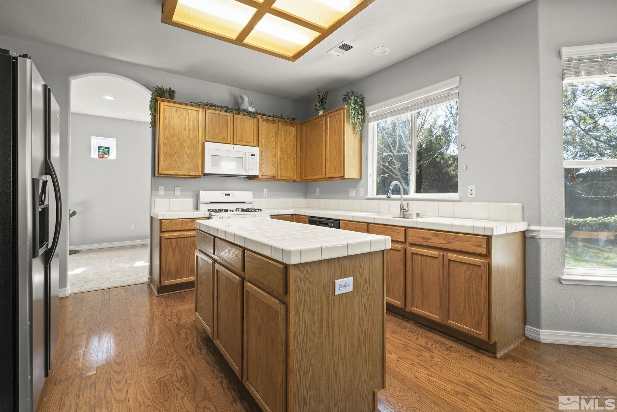 1465 Cayuse Way Reno, NV 89521 - Photo 8 of 26 a kitchen with stainless steel appliances granite countertop a sink stove and refrigerator