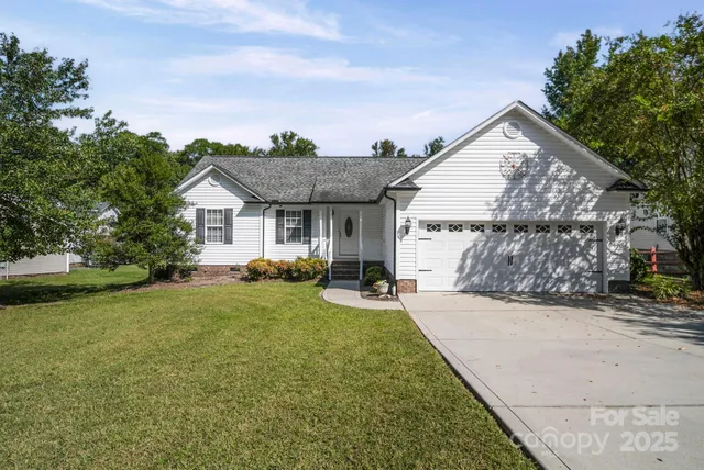 a front view of a house with yard and green space