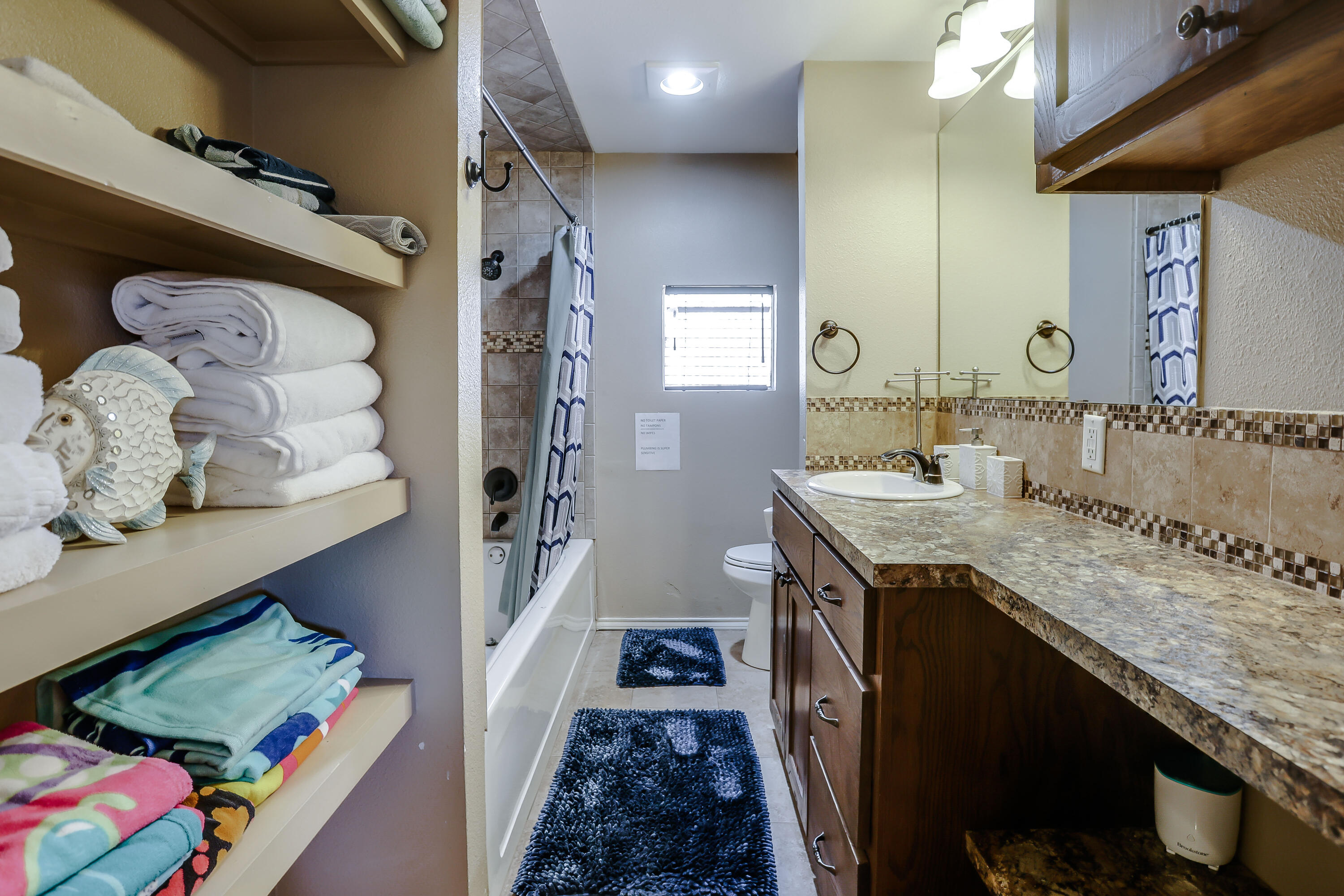 68 Pony Express Trail Lubbock, TX 79404 - Photo 14 of 15 a bathroom with a granite countertop double vanity sink and a mirror