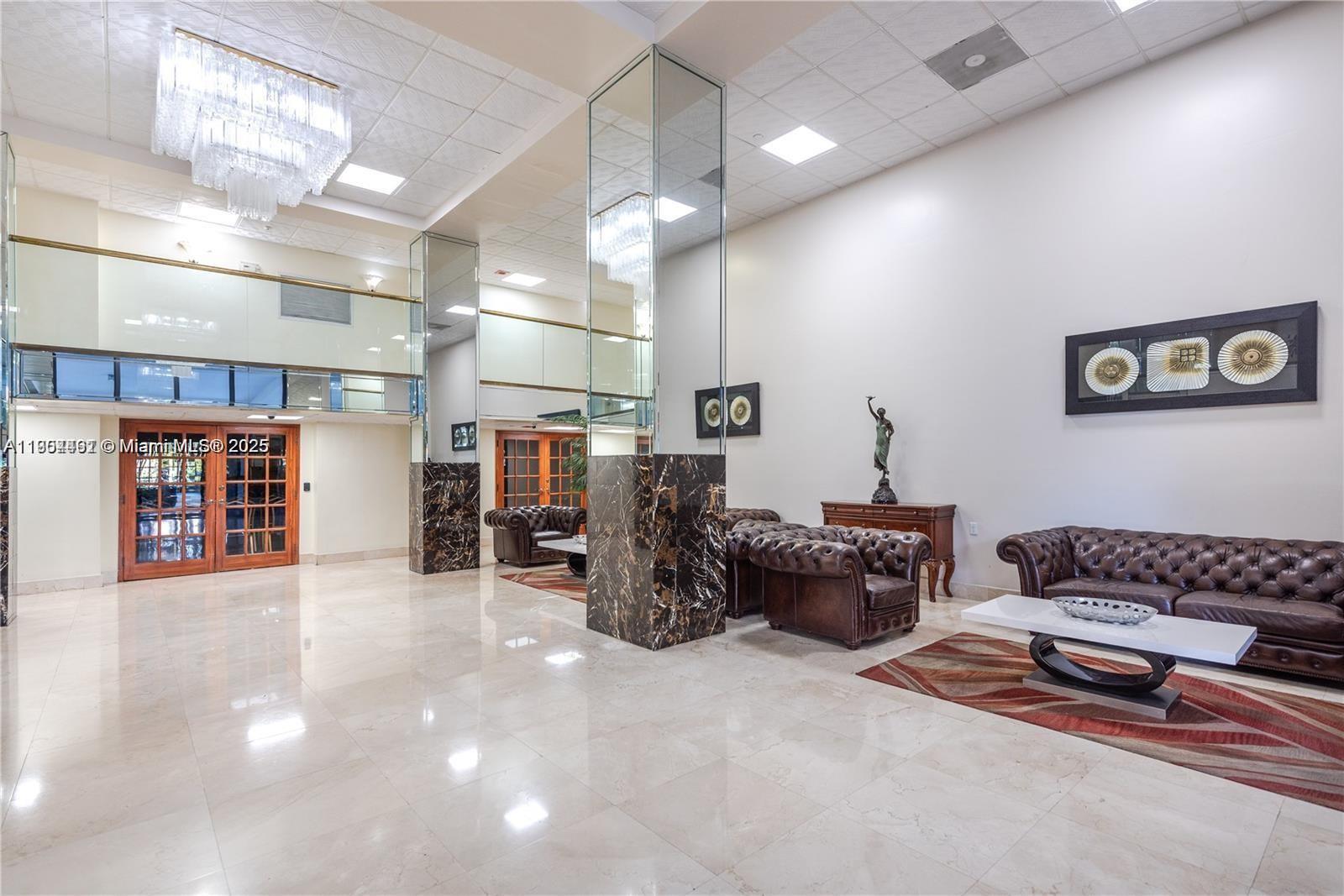 210 174th Street, Unit 2202 Sunny Isles Beach, FL 33160 - Photo 12 of 12 a living room with furniture and a window