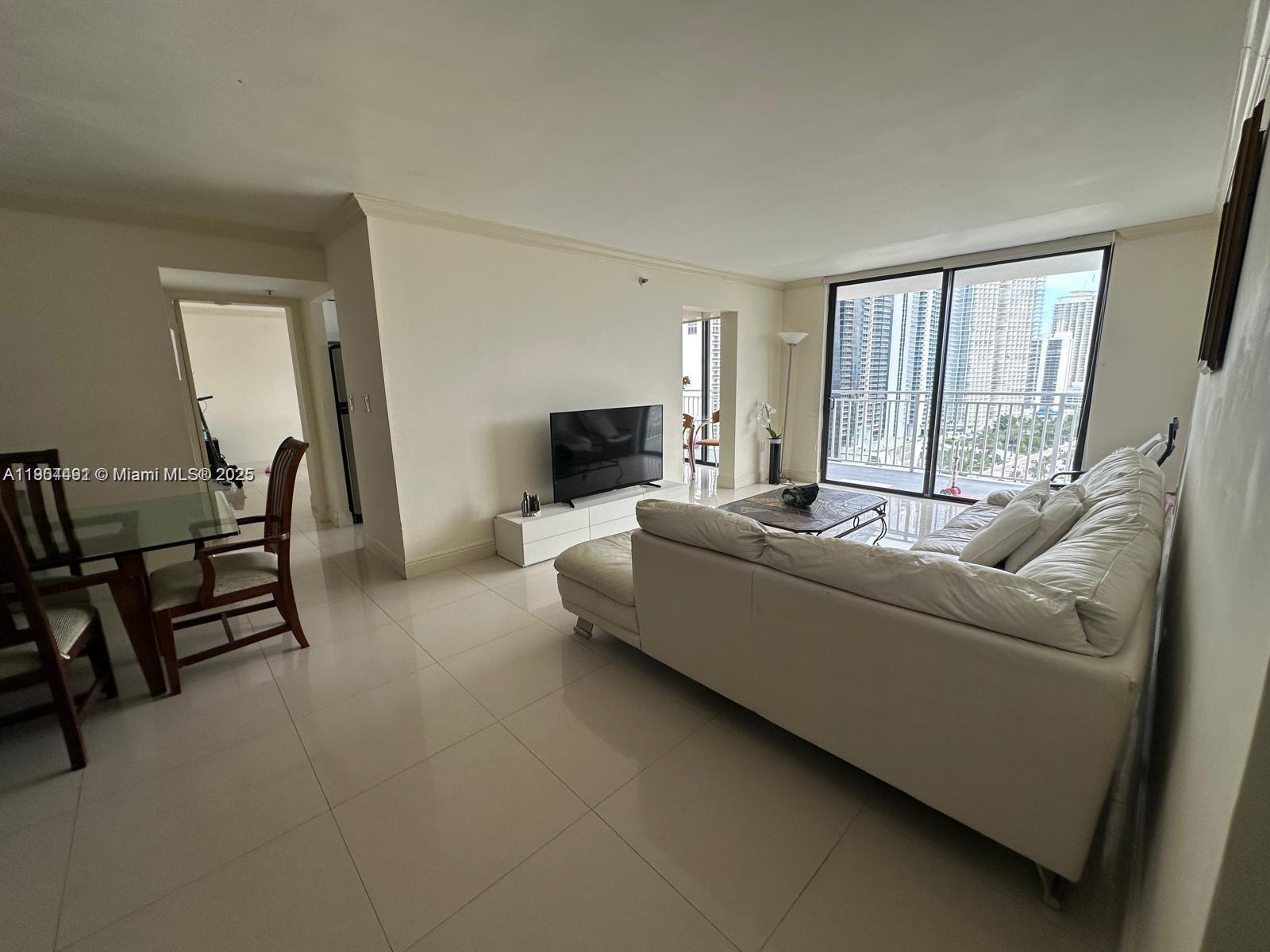 210 174th Street, Unit 2202 Sunny Isles Beach, FL 33160 - Photo 8 of 12 a living room with furniture and a fireplace