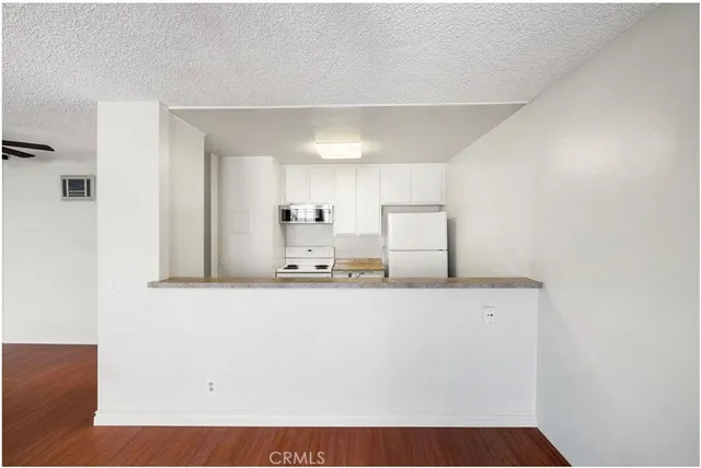 a view of living room with furniture and mirror