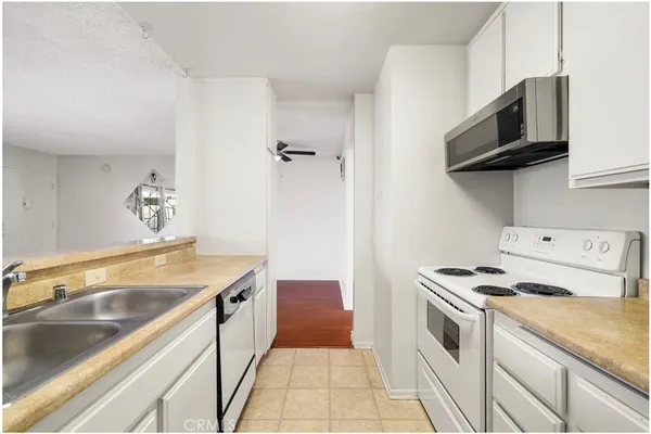 a kitchen with stainless steel appliances granite countertop a sink and a stove