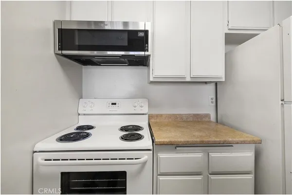 a stove top oven sitting inside of a kitchen