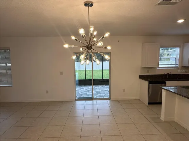 a view of a kitchen with a sink and a chandelier
