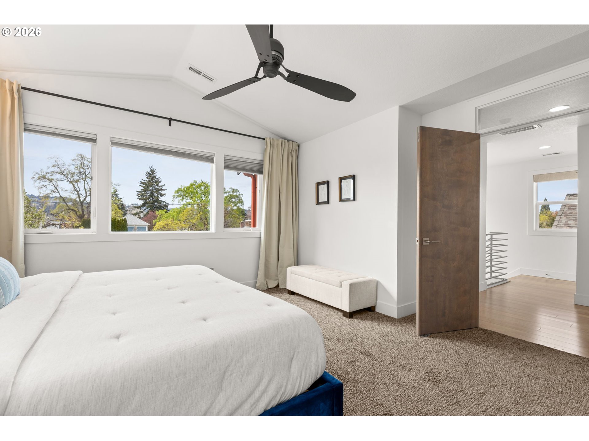 2626 Southeast 16th Avenue Portland, OR 97202 - Photo 34 of 48 a bedroom with a large bed and a chandelier