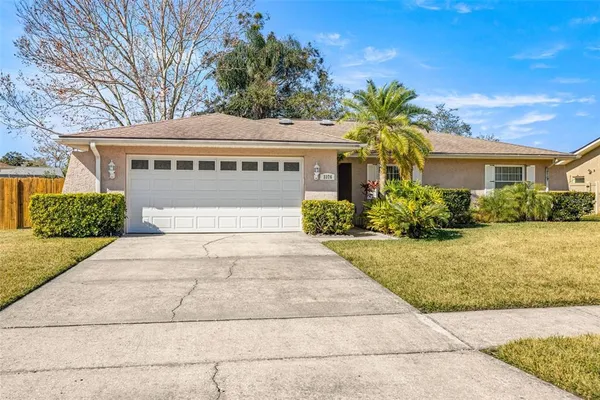 a front view of house with yard and trees around