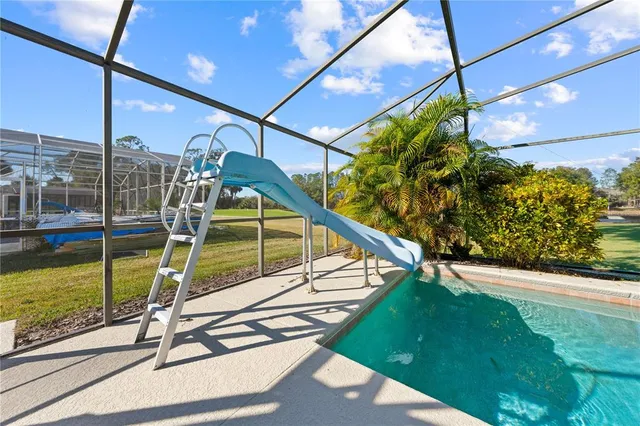 a view of an empty room with a chandelier fan