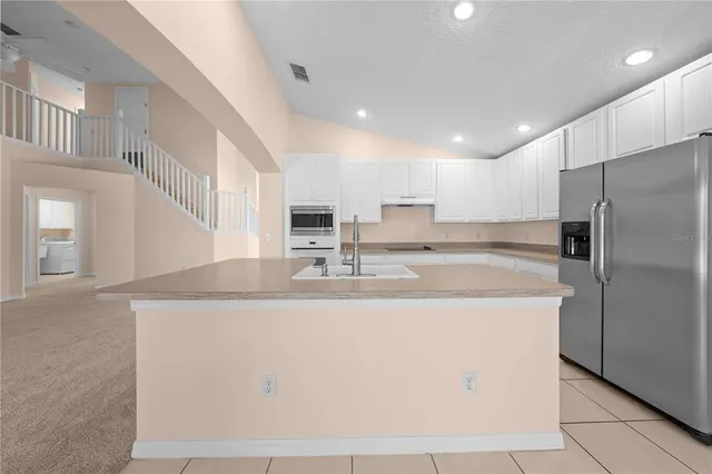 an empty room with a ceiling fan and a window