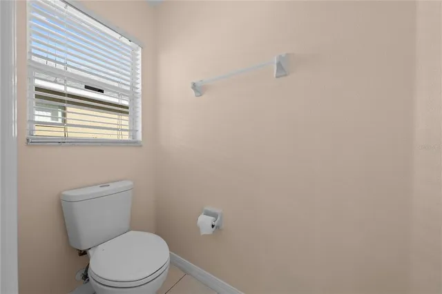 a view of a hallway with wooden floor and entryway