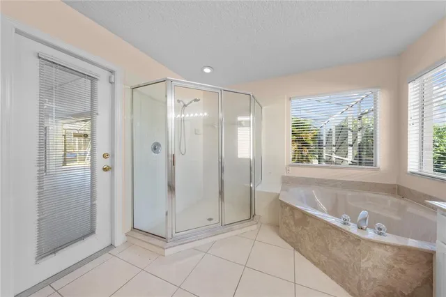 a spacious bathroom with a granite countertop sink a toilet a mirror and shower