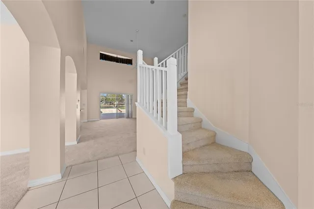 a aerial view of a house with swimming pool and large trees