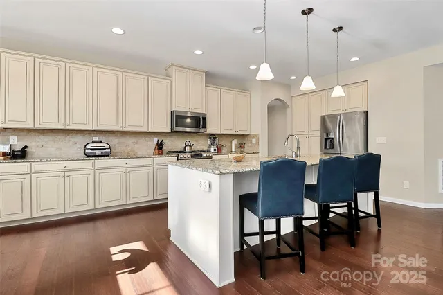 a kitchen with microwave a sink and cabinets