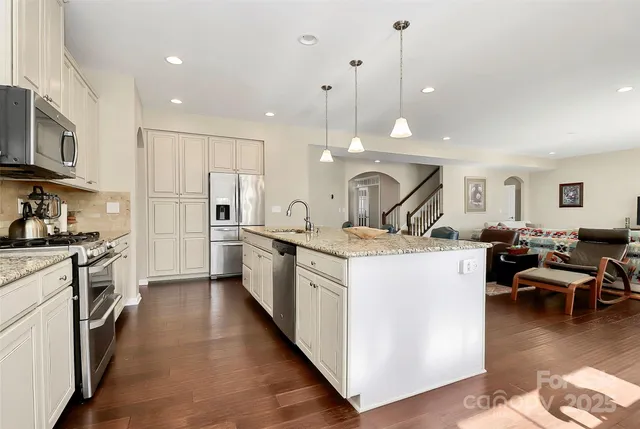 a kitchen with counter top space a sink appliances and cabinets